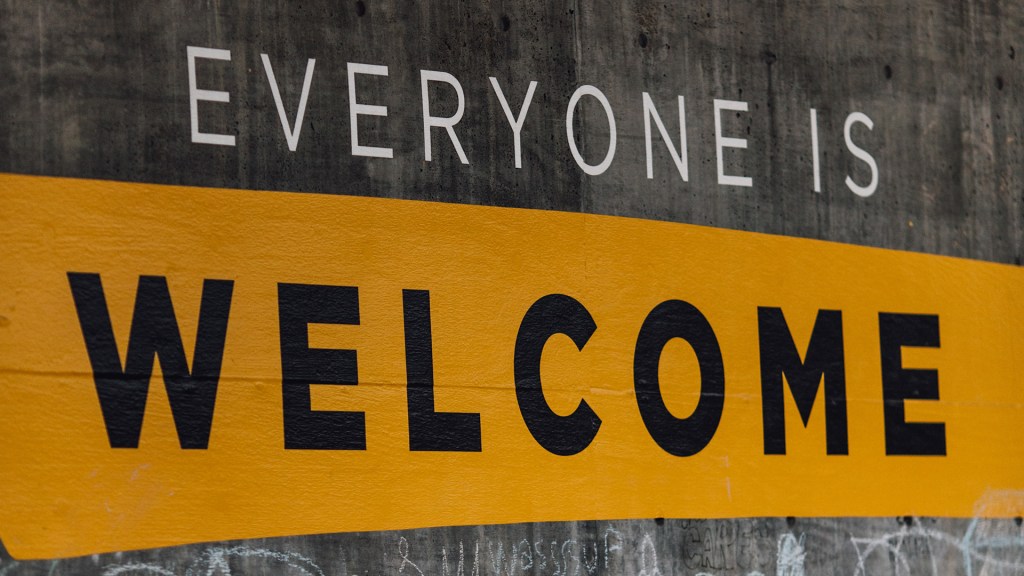The phrase "Everyone is Welcome" painted on a concrete wall